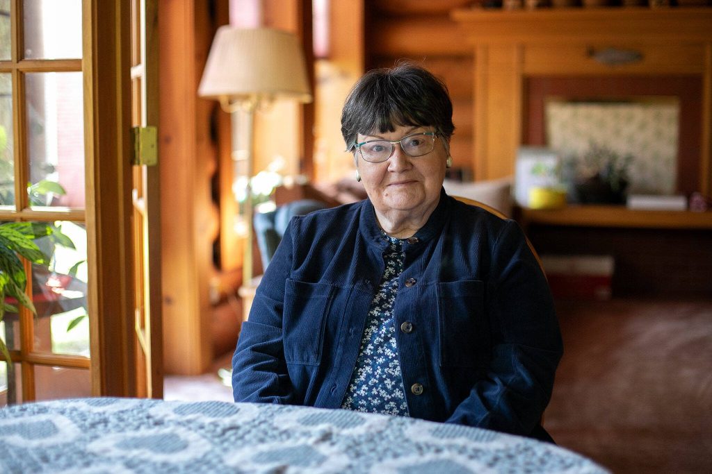 Nancy Rambo, who has lived in Oso near the slide zone since the 1980s, sits in her dining room on Friday, March 15, 2024, in Oso, Washington. (Ryan Berry / The Herald)