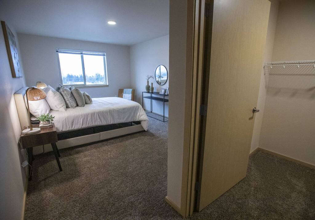 A bedroom and walk in closet in a staged two bedroom apartment int he Four Corners housing complex on Wednesday, Jan. 24, 2024 in Everett, Washington. (Olivia Vanni / The Herald)