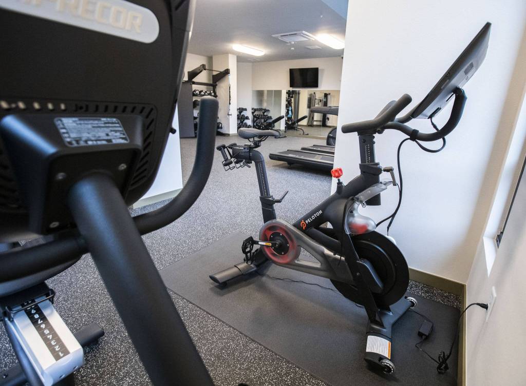 A 24-hour gym with two Peletons at the Four Corners housing complex in Everett. (Olivia Vanni / The Herald)