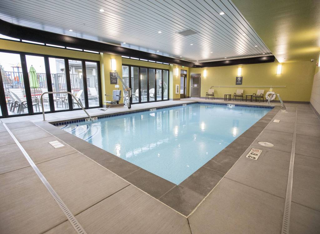 An indoor pool and outdoor hot tub at the Four Corners housing complex on Wednesday, Jan. 24, 2024 in Everett, Washington. (Olivia Vanni / The Herald)