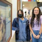 Sydney Vo and Azul Rangel, juniors at Mariner High School, stand in the entrance hallway at Mariner in Everett. The two have won the Congressional App Challenge in Washingtons Second District for the second year in a row, this time for the creation of HopeHorizon. (Ryan Berry / The Herald)