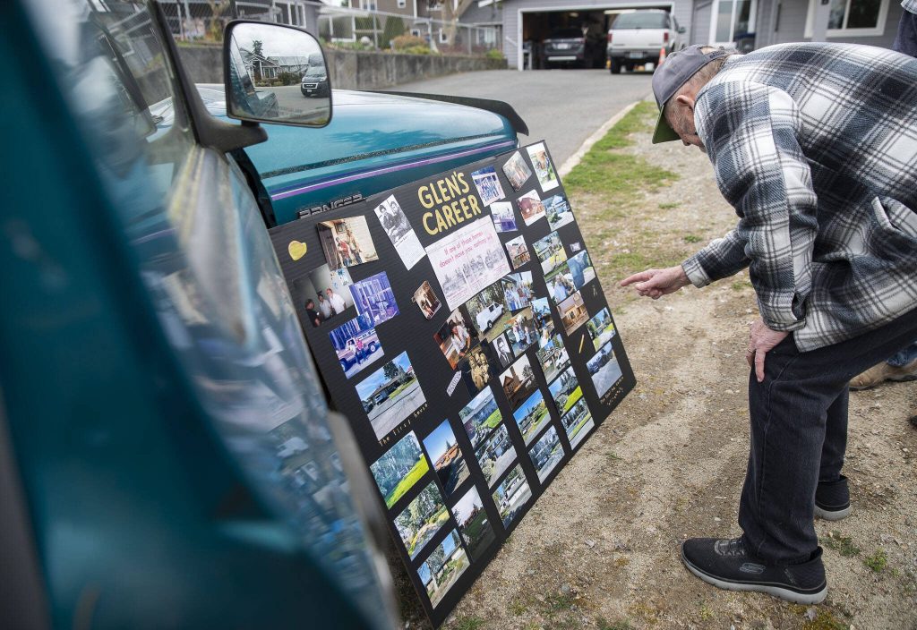 Olin talks about some of the different homes he has built that are pictured on a career memory board on Wednesday, March 20, 2024 in Everett, Washington. (Olivia Vanni / The Herald)