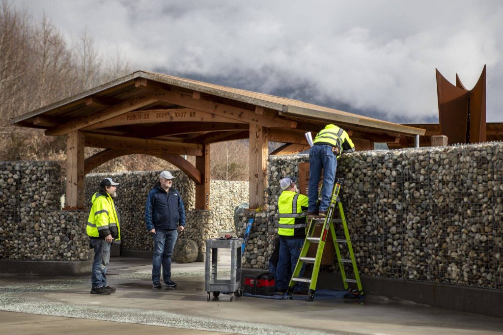 People finish working on the Oso Landslide Memorial on Monday, Feb. 26, 2024, near Oso, Washington. (Annie Barker / The Herald)