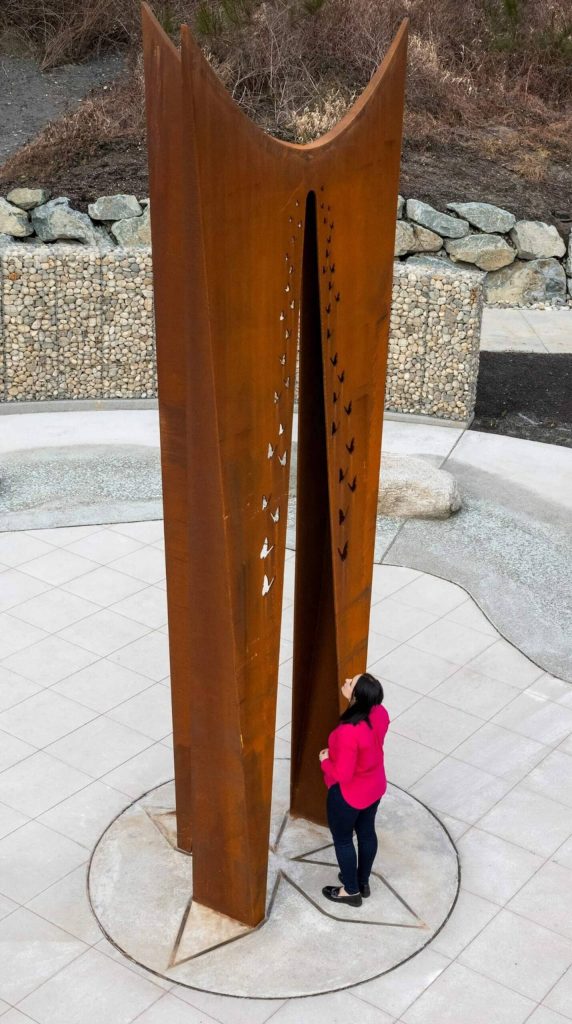 Tsovinar Muradyan stands next to the 19-foot beacon she designed for the Oso Landslide Memorial. (Photo provided by Vaghinak Petrosyan)