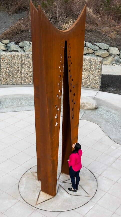 Tsovinar Muradyan stands next to the 19-foot beacon she designed for the Oso Landslide Memorial. (Photo provided by Vaghinak Petrosyan)