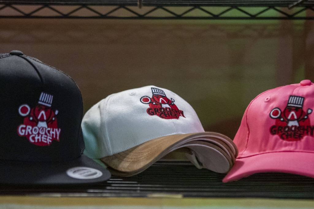 Hats sit on display inside the Grouchy Chef on Sunday, March 3, 2024 in Mukilteo, Washington.(Annie Barker / The Herald)