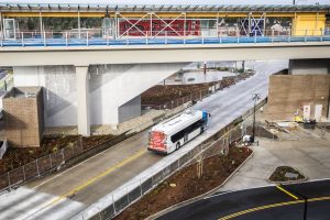 A Community Transit bus drives underneath Sound Transit’s Link Lynnwood City Center Station on Thursday, Dec. 28, 2023 in Lynnwood, Washington. (Olivia Vanni / The Herald)
