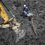 Workers and machinery search through debris for the two remaining missing persons in Oso on April 23, 2014. (Genna Martin / The Herald)