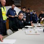 First responders gather inside the Oso Fire Department after a fatal mudslide washed over Highway 530 and the surrounding area just east of Oso, Saturday morning, March 22, 2014. (Annie Mulligan / For The Herald)