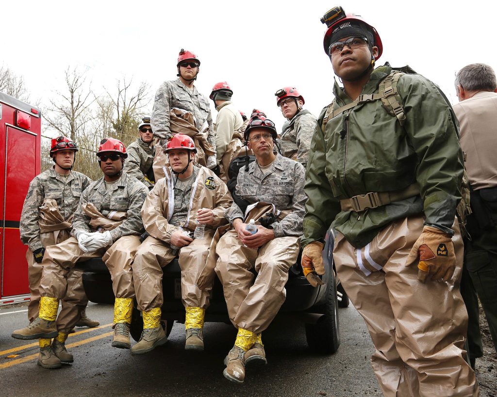 National Guard troops prepare to enter the mudslide debris on the western edge of the mudslide where it covers Highway 530 Wednesday, March 26, 2014 morning east of Oso, Wash. (Mark Mulligan / The Herald)
