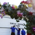 (LtoR) Chaplains Ray Thompson, Karen Solberg and Barbara Gilreath adjust the reader board at the Oso Community Chapel in Oso, Wash., on Tuesday, April 1, 2014. (Mark Mulligan / The Herald)