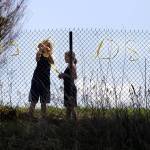 Ava Yeckley and Darby Morgan, both Arlington residents, put up a sign reading  We heart Oso on the 530 highway, Tuesday, April 1, 2014, near Arlington, Wash. (Sofia Jaramillo / The Herald)