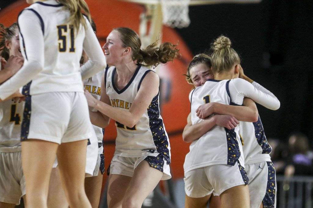 Mead players celebrate after a 3A semifinal game between Snohomish and Mead at the Tacoma Dome on Friday, March 1, 2024 in Tacoma, Washington. Snohomiosh fell, 56-50. (Annie Barker / The Herald)