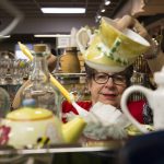 Volunteer Judi Drake dusts around teapots at the Assistance League of Everett on Nov. 18. The gruop sell items at their thrift store and donates the proceeds to Snohomish County families. All 300 people who help out are volunteers. (Andy Bronson / The Herald)