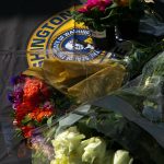 Flowers for slain trooper Chris Gadd begin to accumulate outside Washington State Patrols District 7 Headquarters on Saturday, March 2, 2024, in Marysville, Washington. (Ryan Berry / The Herald)