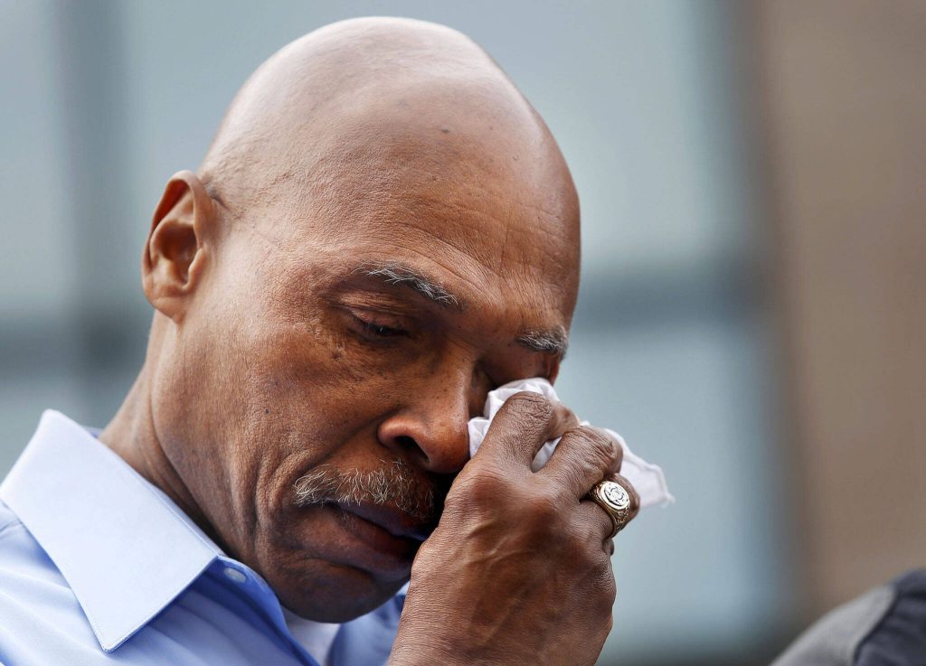 Snohomish County Executive John Lovick wipes a tear during a briefing in downtown Arlington Monday morning, March 24, 2014. (Annie Mulligan / The Herald)