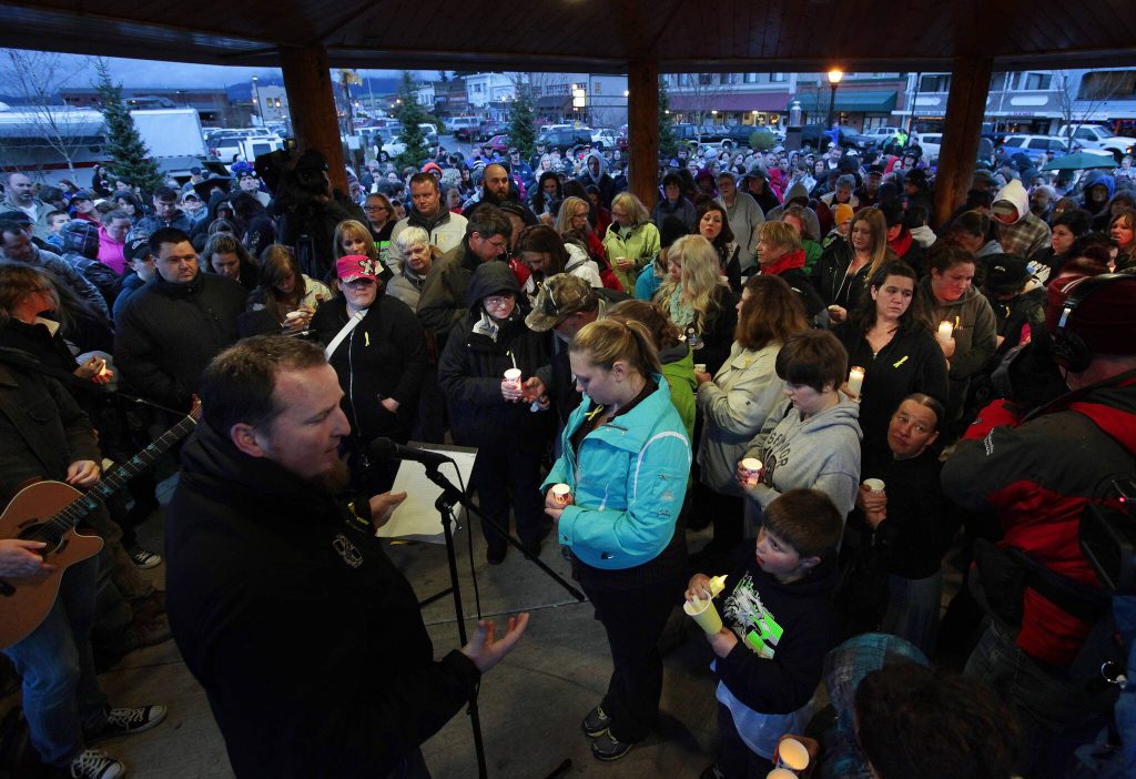 Attendees of a candlelight vigil at Legion Memorial Park in Arlington, Washington pray together on March 25, 2014. (Mark Mulligan / The Herald)