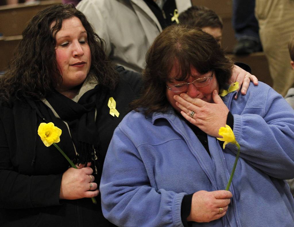 A woman becomes emotional during a prayer service at Haller Middle School in Arlington, Washington, on June 22, 2014. (Genna Martin / The Herald)