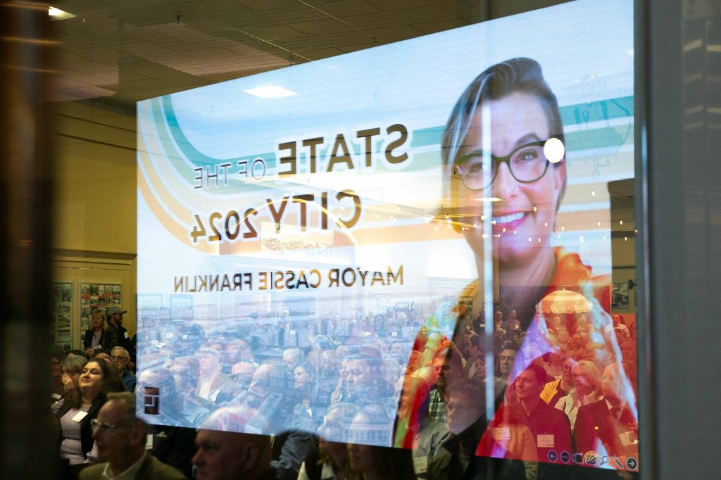 An image of Everett Mayor Cassie Franklin is reflected in a storefront window during the State of the City Address on Thursday, March 21, 2024, at the Everett Mall in Everett, Washington. (Ryan Berry / The Herald)
