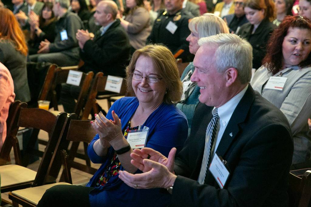 Lynnwood Mayor Christine Frizzell and Mukilteo Mayor Joe Marine sit together during Everetts State of the City Address on Thursday, March 21, 2024, at the Everett Mall in Everett, Washington. (Ryan Berry / The Herald)