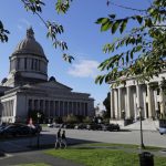 Afternoon sun illuminates the Legislative Building (left) at the Capitol in Olympia, in October, 2018. (Ted S. Warren / Associated Press)