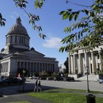 FILE - The afternoon sun illuminates the Legislative Building, left, at the Capitol in Olympia, Wash., Oct. 9, 2018. Three conservative-backed initiatives that would give police greater ability to pursue people in vehicles, declare a series of rights for parents of public-school students and bar an income tax were approved by the Washington state Legislature on Monday, March 4, 2024.   (AP Photo/Ted S. Warren, File)