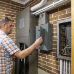Lakewood District Facilities Director Alex VanDuine opens one of the dated electric boxes at Lakewood Elementary School on Tuesday, March 19, 2024, in Marysville, Washington. (Olivia Vanni / The Herald)