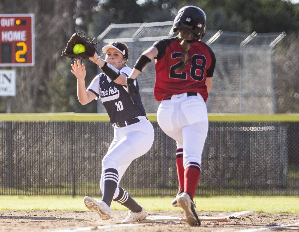 Glacier Peaks Emma Hirshorn catches a throw to get Snohomishs Shelby Gilbert out at first during the game on Friday, March 15, 2024 in Snohomish, Washington. (Olivia Vanni / The Herald)