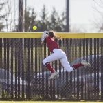 Snohomishs Avery Clark leaps to try and catch a ball as it goes over the outfield fence during the game Glacier Peak on Friday, March 15, 2024 in Snohomish, Washington. (Olivia Vanni / The Herald)