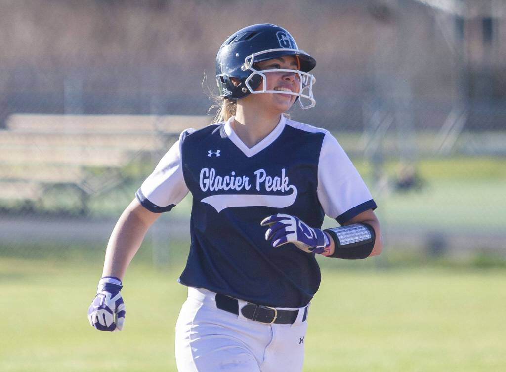 Glacier Peaks Samantha Christensen smiles as she runs around the bases after hitting a home run during the game against Snohomish on Friday, March 15, 2024 in Snohomish, Washington. (Olivia Vanni / The Herald)