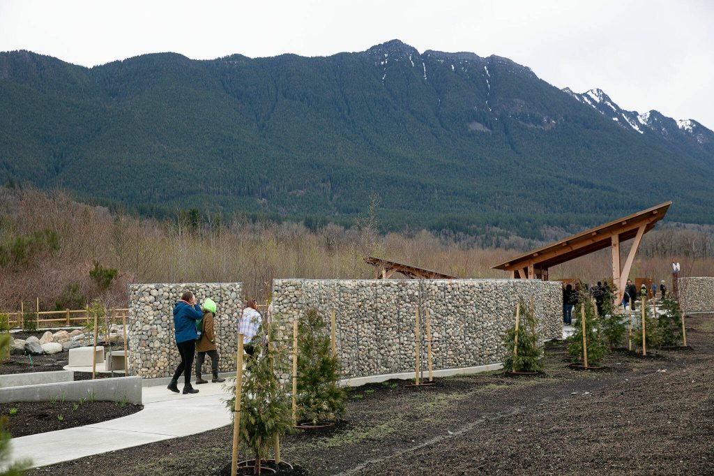 People filter through the Oso Landslide Memorial after the ten-year remembrance of the slide on Friday, March 22, 2024, at the Oso Landslide Memorial in Oso, Washington. (Ryan Berry / The Herald)