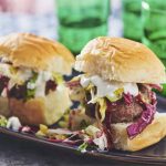 This April 2019 image shows a recipe for chipotle sliders with a colorful lettuce slaw and blue cheese dressing in New York. (Cheyenne Cohen via AP)
