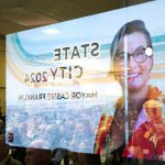 An image of Everett Mayor Cassie Franklin is reflected in a storefront window during the State of the City address on Thursday, at the Everett Mall. (Ryan Berry / The Herald)
