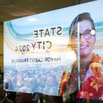An image of Everett Mayor Cassie Franklin is reflected in a storefront window during the State of the City Address on Thursday, March 21, 2024, at thee Everett Mall in Everett, Washington. (Ryan Berry / The Herald)