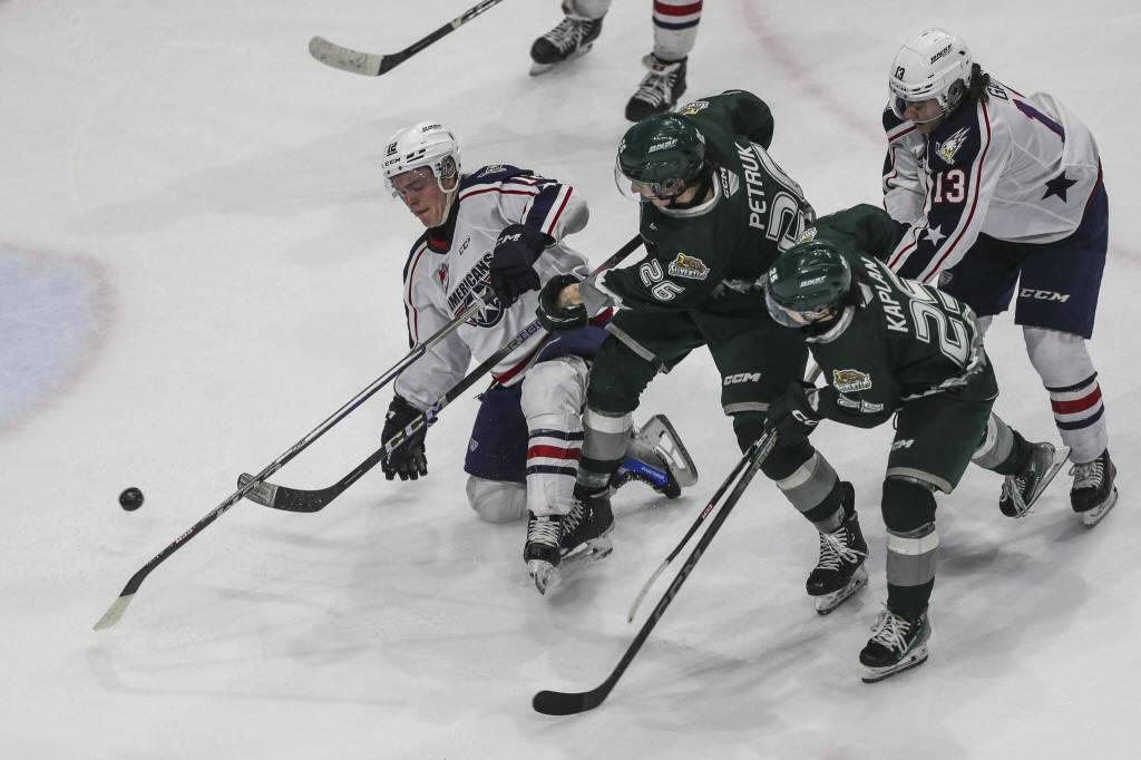 Silvertips Andrew Petruk (26) fights for the puck during a game against the Tri-City Americans at the Angel of the Winds Arena on Sunday in Everett. (Annie Barker / The Herald)