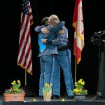 Captain Ron Mead and Corporal Alexis Robinson embrace during a memorial for Washington State Trooper Chris Gadd on Tuesday, March 12, 2024, at Angel of the Winds Arena in Everett, Washington. (Ryan Berry / The Herald)