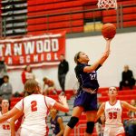Kamiaks Bella Hasan finishes at the rim with a driving layup against Stanwood on Nov. 30, 2023, at Stanwood High School in Stanwood. (Ryan Berry / The Herald)