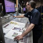 Alex Hanson looks over sections of the Herald and sets the ink on Wednesday, March 30, 2022 in Everett, Washington. (Olivia Vanni / The Herald)