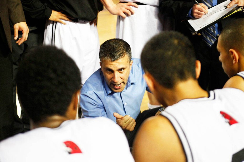 Mountlake Terrace head coach Nalin Sood talks to his team during a timeout in the second half of its state quarterfinal game against Lincoln on Feb 28, 2013. (Genna Martin / The Herald)