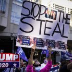 FILE - Supporters of President Donald Trump gather with some signs claiming a stolen election outside the Philadelphia Convention Center as they await general election tabulation results, Friday, Nov. 6, 2020, in Philadelphia. (AP Photo/John Minchillo, File)