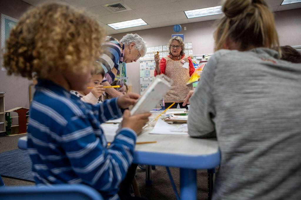 Bobbi Samples leads a painting exercise during the Afternoon of the Arts program, where students spend part of the day on an art project at Utsalady Elementary on March 22, 2024 in Camano, Washington. (Annie Barker / The Herald)