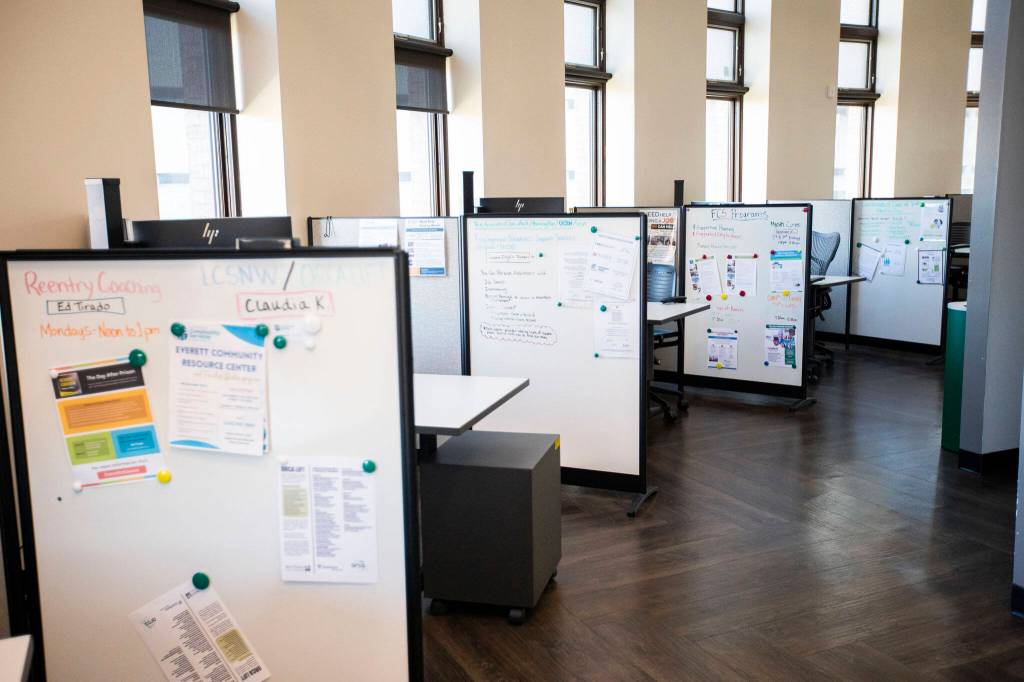 A row of desks for different service providers at the Carnegie Resource Center on Friday, Feb. 16, 2024 in Everett, Washington. (Olivia Vanni / The Herald)
