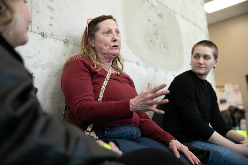 Marcella Wannquist waits in line for a hair cut during a resource fair at the Carnegie Resource Center on Wednesday, March 6, 2024, in downtown Everett, Washington. (Ryan Berry / The Herald)