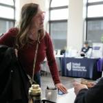Marcella Wannquist collects a QFC gift card she won during a resource fair at the Carnegie Resource Center on Wednesday, March 6, 2024, in downtown Everett, Washington. (Ryan Berry / The Herald)