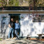 Allan and Frances Peterson, a woodworker and artist respectively, stand in the door of the old horse stall they turned into Milkwood on Sunday, March 31, 2024, in Index, Washington. (Ryan Berry / The Herald)