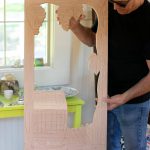 Allan Peterson holds up a work-in-progress door to a wine cabinet hes working on on Sunday, March 31, 2024, in Index, Washington. (Ryan Berry / The Herald)