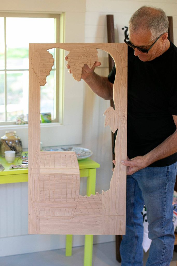 Allan Peterson holds up a work-in-progress door to a wine cabinet hes working on on Sunday, March 31, 2024, in Index, Washington. (Ryan Berry / The Herald)