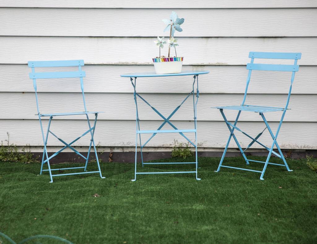 Blue outdoor furniture and pinwheels are visible outside of one of the homes in Royalwood Estates Mobile Home Park on Monday, March 11, 2024 in Lynnwood, Washington. (Olivia Vanni / The Herald)