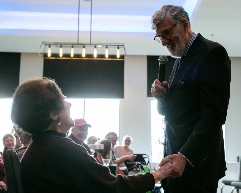 Graham Kerr, the Galloping Gourmet, walks over and holds the hand of his wife Nancy while speaking during Senior Expo on Tuesday, March 26, 2024, at Hotel Indigo in Everett, Washington. (Ryan Berry / The Herald)