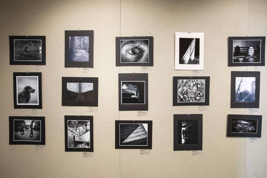 The wall of Honorable Mention photographs in the 2024 Annual Black and White Photography Contest on display at the Schack Art Center on Thursday, April 18, 2024 in Everett, Washington. (Olivia Vanni / The Herald)